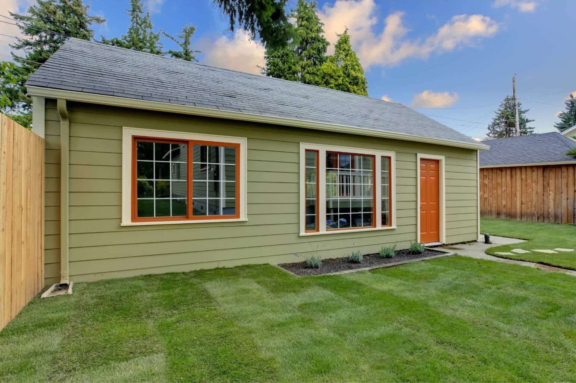 Small home with green paneling and two large windows