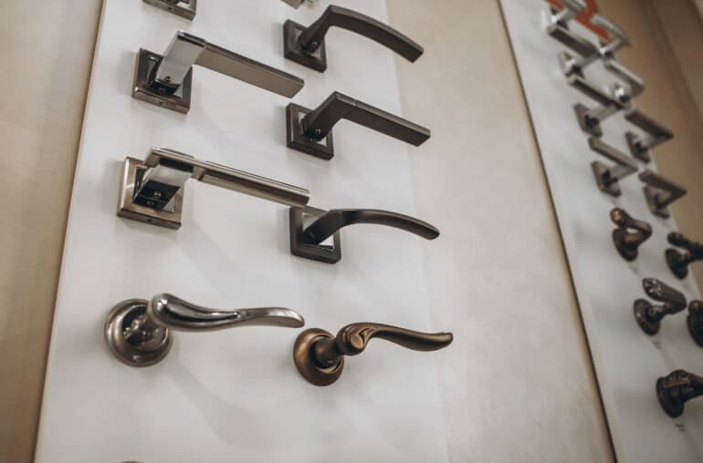 Wall full of different styled hinge door handles